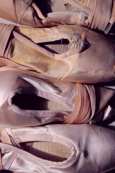 Cropped shot of an old pointe shoes. Cropped Shot Of Ballet Shoes. Abstract Ballet Background. Pointe shoes Background. - Fotó, kép
