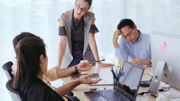 Unhappy business people in group meeting in office. The team is frustrated because of project failure. Business problem and crisis concept. - 写真・画像