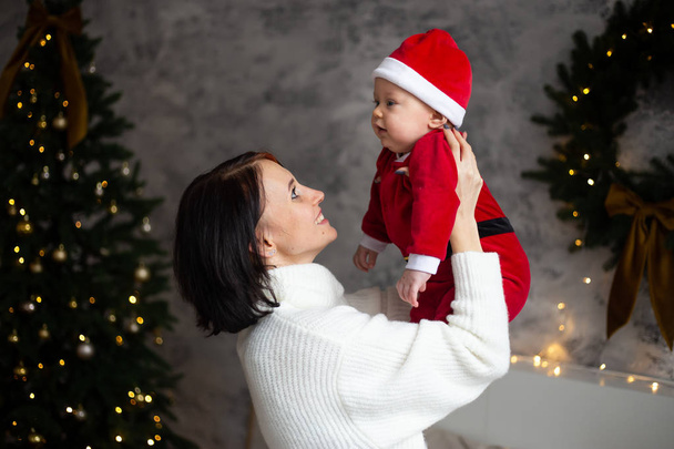Happy family mother and baby playing home on Christmas holidays. - 写真・画像
