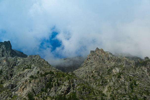 Rocks under blue sky with clouds. Mountain Hiking, summer tourism - Fotoğraf, Görsel
