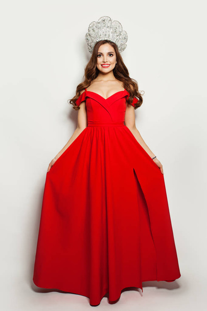 Fashion model woman in red blowing dress and diamond crown  - Zdjęcie, obraz