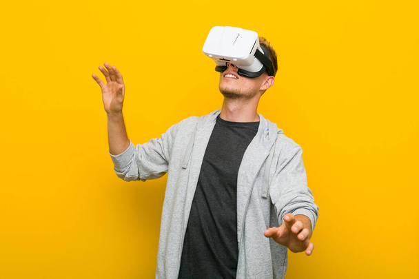 Νέος Καυκάσιος άνθρωπος χρησιμοποιώντας ένα εικονικό γυαλιά πραγματικότητας - Φωτογραφία, εικόνα