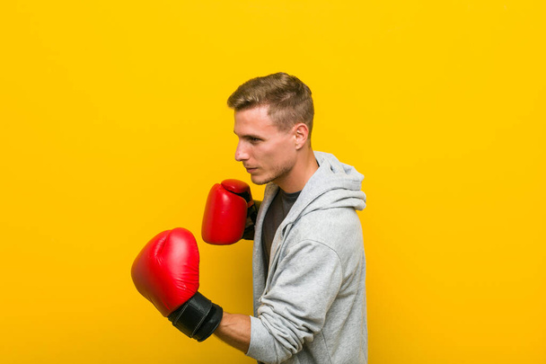 Young caucasian man wearing a boxing gloves - Photo, Image