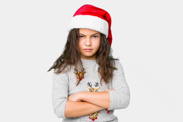 Little girl celebrating christmas day frowning face in displeasure, keeps arms folded. - Photo, Image