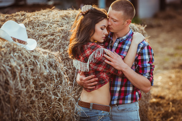 Couple embracing near hay - Valokuva, kuva