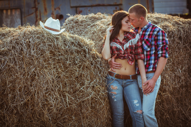 Couple embracing near hay - Foto, Imagen