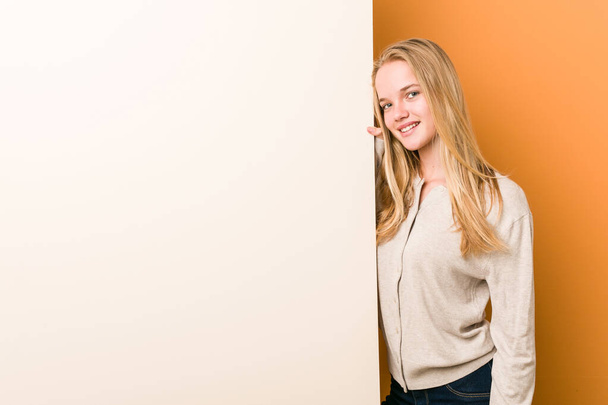 Young caucasian woman with copy space happy, smiling and cheerful. - Photo, Image