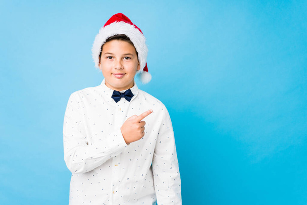 Elegant kid wearing a santa hat on a christmas day - Photo, Image