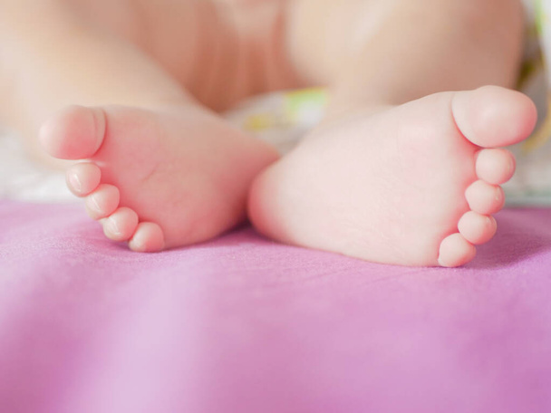 Feet of a sleeping newborn baby. Feet of a sleeping newborn baby close up. Place for writing. Placing text. - Foto, imagen