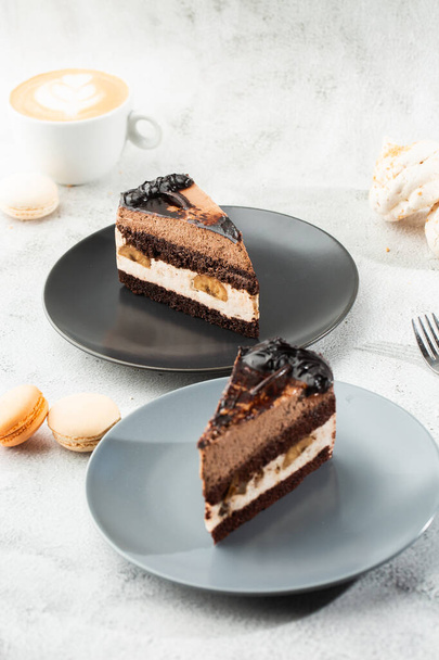 Banana chocolate cake on gray plate on marble background. Selective focus. Vertical photo. Menu for bakery. cafe menu. Pastry. Delicious and sweet dessert at cafe restaurant. - Photo, image