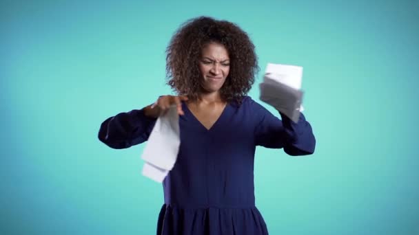 Angry furious female african american office worker throwing crumpled paper, having nervous breakdown at work, stress management. Serious businesswoman tearing contract in pieces. - Кадри, відео