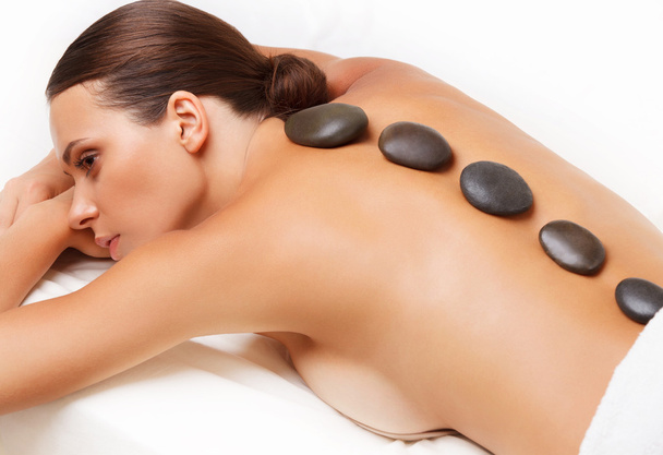 Stone Massage. Beautiful Woman Getting Spa Hot Stones Massage. S - Valokuva, kuva