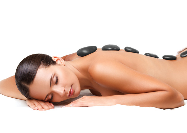 Stone Massage. Beautiful Woman Getting Spa Hot Stones Massage. S - 写真・画像