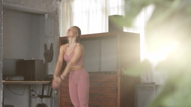 Young woman makes yoga in her home studio - Filmati, video