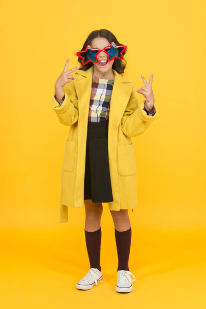Party girl. Happy child make victory hand gestures. Little kid celebrate victory yellow background. Cute small winner enjoy victory party. School competition. Victory and triumph - Photo, Image