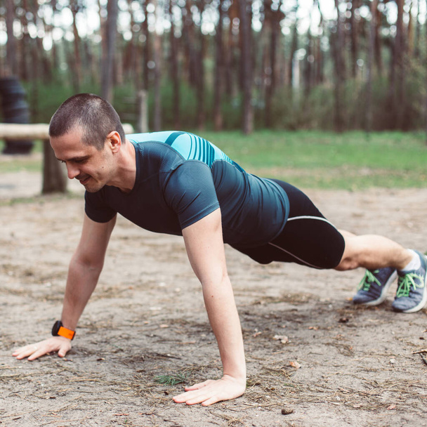 Man is doing outdoor exercise push ups - Photo, Image