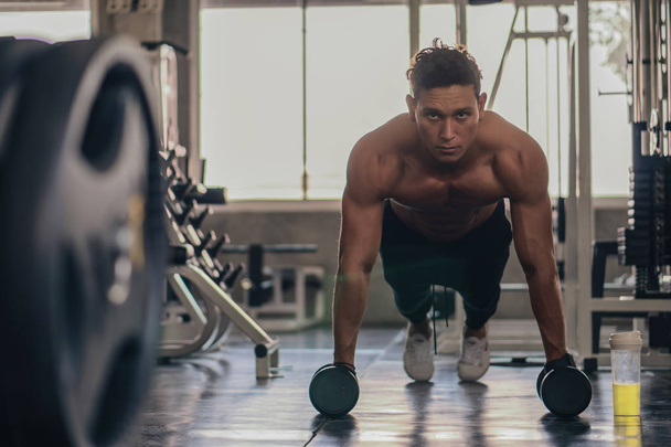 caucasian man having workout for bodybuilding by pushing up with - Valokuva, kuva