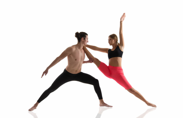 Overall fitness. Couple of athletes isolated on white. Athletic man and woman perform pilates workout. Full body athletic class. Sexy sportsman and sportswoman. Athletic training. Athletic and strong - Foto, afbeelding