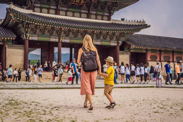 Mom and son tourists in Korea. Gyeongbokgung Palace grounds in Seoul, South Korea. Travel to Korea concept. Traveling with children concept - Photo, image