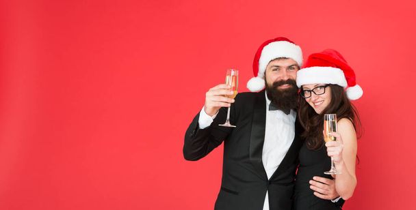 Sparkling wine. Office party. Visiting event party ceremony. Couple ready corporate party. Happy new year. Bearded gentleman wear tuxedo girl elegant dress copy space red background. Merry christmas - Fotografie, Obrázek