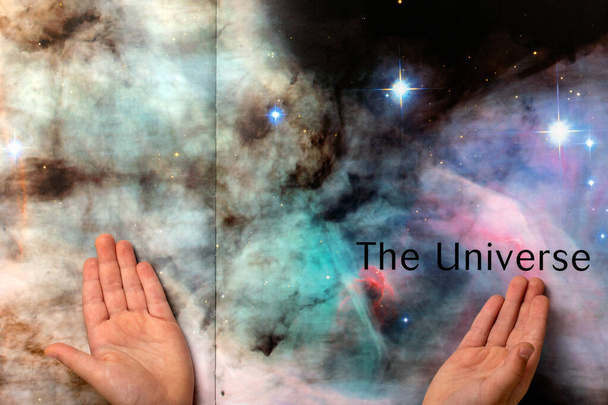 Kinderhanden wijzend naar het Universum in Boek Pagina 's - Foto, afbeelding