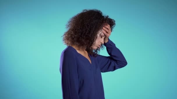 Businesswoman is tired of work, she disappointed, helpless. Frustrated african american girl over blue background. Concept of problems and headache. - Video
