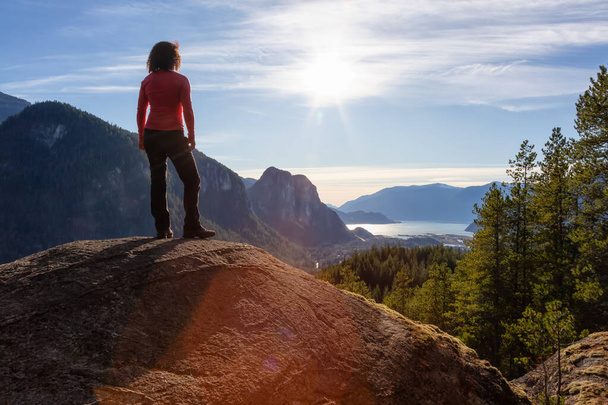 Güneşli bir sonbahar akşamı dağlarda yürüyüş yapan maceraperest kız. Götürülmüş Squamish, Vancouver 'ın kuzeyi, British Columbia, Kanada. - Fotoğraf, Görsel