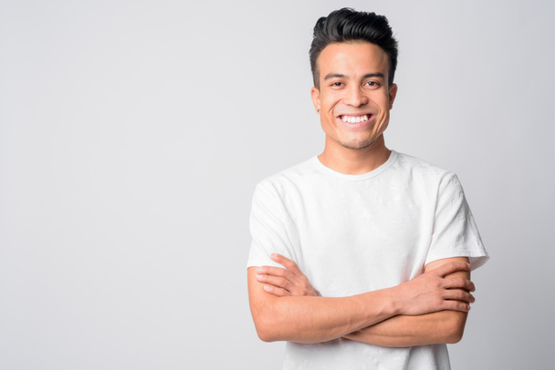 Portrait of happy young Asian man smiling with arms crossed - Photo, Image