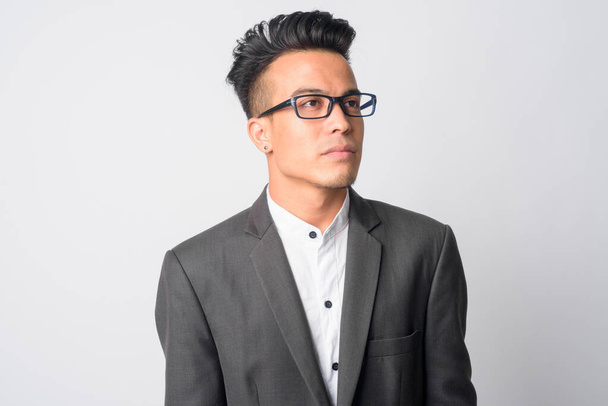 Face of young Asian businessman with eyeglasses thinking - Fotó, kép