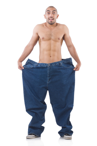 Man in dieting concept with oversized jeans - 写真・画像