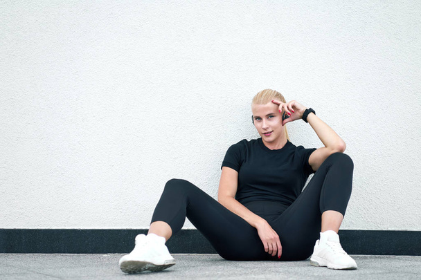 Giovane donna sportiva che indossa abbigliamento sportivo nero e sne bianco alla moda
 - Foto, immagini