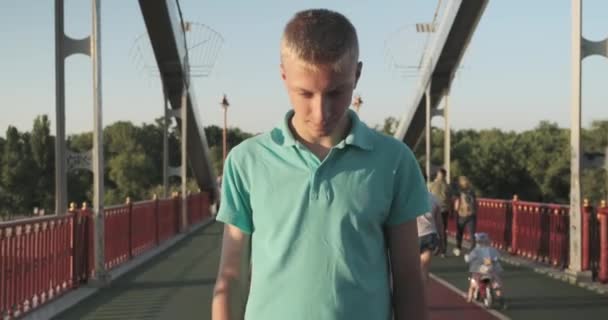 Smiling teenager 15, 16 years old blond boy posing looking at the camera - Video, Çekim