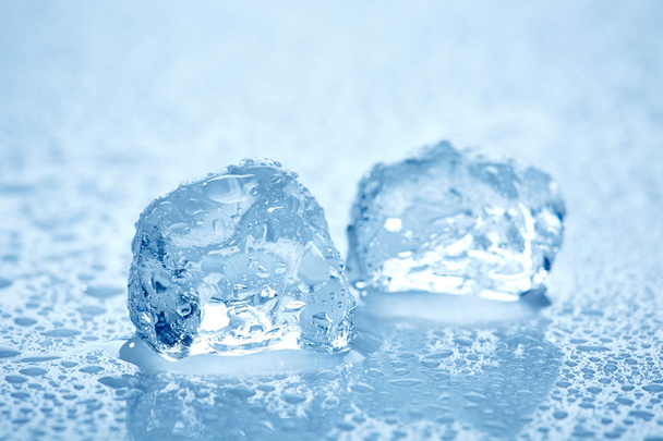 ice cubes on a wet light blue background - Фото, изображение
