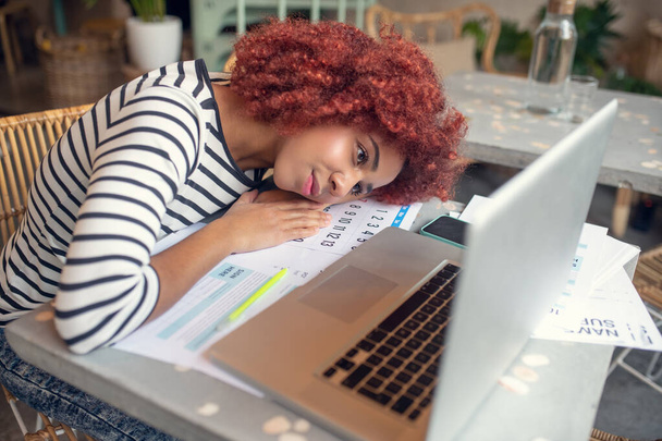 Young businesswoman feeling exhausted after filling tax declaration - Fotoğraf, Görsel