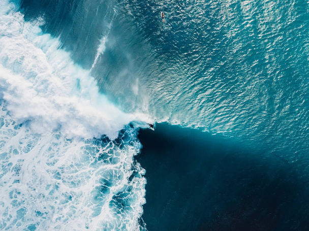 Aerial view with surfers and wave in crystal ocean. Top view - Photo, image
