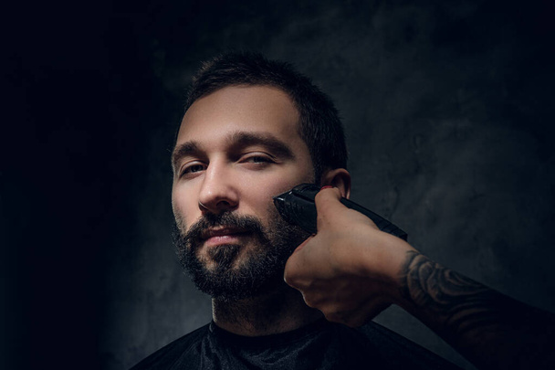 Portrait of male, wich gets a beard care from woman - Fotografie, Obrázek