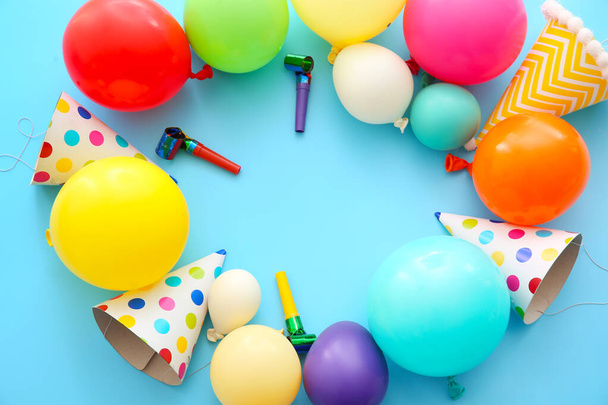 Frame made of balloons and party hats on color background - Photo, Image