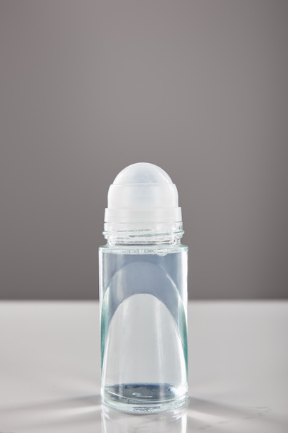 roll on bottle of deodorant on marble table isolated on grey - Fotoğraf, Görsel