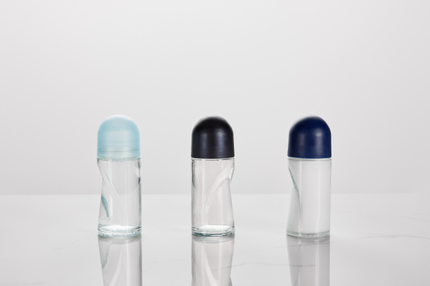 transparent bottles of roller deodorant isolated on white - Foto, Imagem