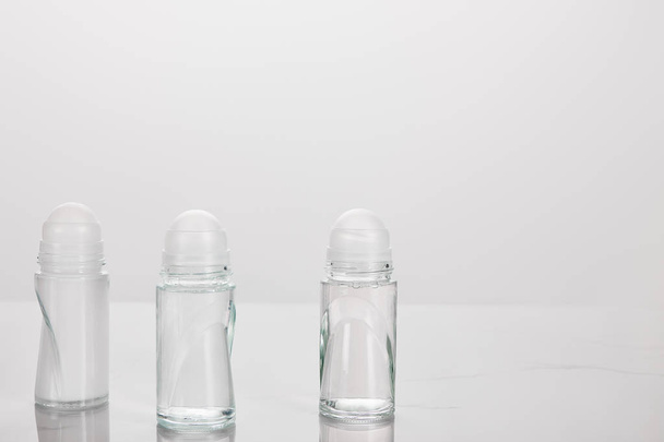 transparent bottles of deodorant isolated on white - Foto, Imagem