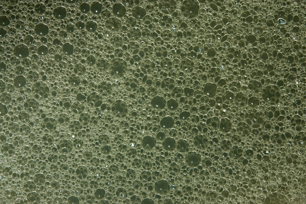 Texture of soap water on a gray-green background - Photo, Image