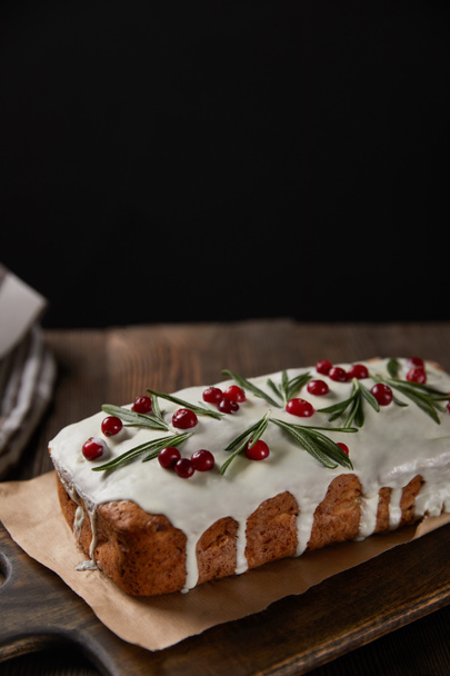 traditional Christmas cake with cranberry on wooden table isolated on black - Фото, зображення