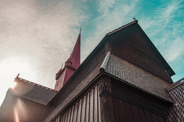 Low angle shot of a brown parish under the cloudy sky in Norway - Foto, Bild