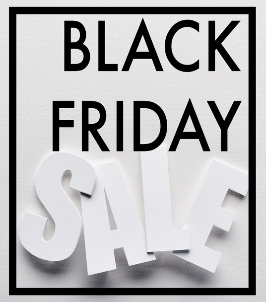 top view of black friday sale lettering on white background - Foto, Bild