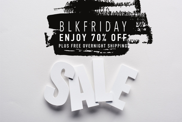 top view of white sale lettering on white background with black Friday, 70 percent off illustration - Φωτογραφία, εικόνα