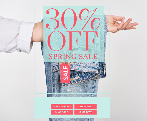 cropped view of woman holding hanging jeans with sale label isolated on white with spring sale 30 percent off illustration - Foto, immagini