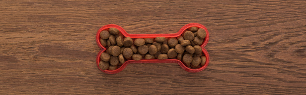 top view of dry pet food in bone on wooden table, panoramic shot - Photo, Image