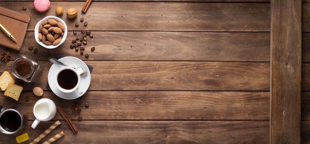 cup of coffee and beans on wooden background - Фото, зображення