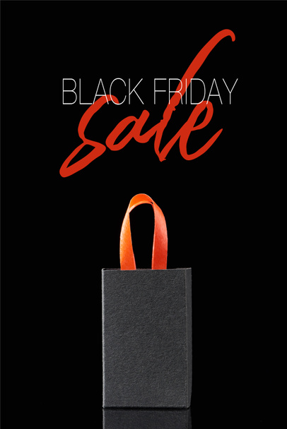 paper shopping bag with red handle isolated on black with black Friday sale illustration  - Valokuva, kuva