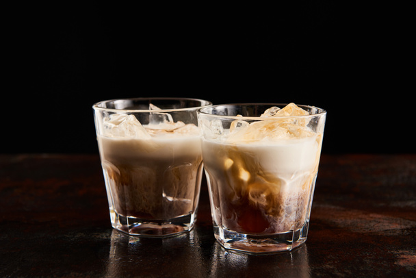 fresh white russian cocktail in glasses isolated on black - Foto, Bild